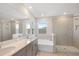 Bathroom featuring double vanity, garden view, soaking tub and shower at 4322 Silo Port Ct, Lakewood Ranch, FL 34211