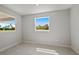 Bright bedroom with two windows and neutral wall colors at 4322 Silo Port Ct, Lakewood Ranch, FL 34211