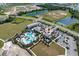 Aerial view of community pool, clubhouse, and surrounding landscape at 4322 Silo Port Ct, Lakewood Ranch, FL 34211
