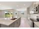 Open concept kitchen with stainless steel appliances and view to backyard at 4322 Silo Port Ct, Lakewood Ranch, FL 34211