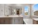 Elegant bathroom with double vanity, large mirror, and garden views at 4322 Silo Port Ct, Lakewood Ranch, FL 34211