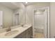 Double vanity bathroom with gray cabinets and a separate tub and shower at 4322 Silo Port Ct, Lakewood Ranch, FL 34211