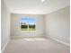 Spacious bedroom with neutral walls and carpet, featuring a large window at 4322 Silo Port Ct, Lakewood Ranch, FL 34211
