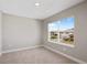 Bright bedroom with large window and neutral wall colors at 4322 Silo Port Ct, Lakewood Ranch, FL 34211