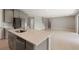 Modern kitchen with island, stainless steel appliances, and white quartz countertops at 4322 Silo Port Ct, Lakewood Ranch, FL 34211
