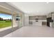 Modern kitchen with gray cabinets, island, and view of backyard from sliding doors at 4322 Silo Port Ct, Lakewood Ranch, FL 34211