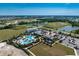 Aerial view of community pool, clubhouse, and surrounding landscape at 4322 Silo Port Ct, Lakewood Ranch, FL 34211