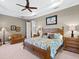 Primary bedroom with king-size bed, and neutral decor; ample natural light at 576 Fore Drive, Bradenton, FL 34208