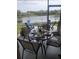 Enjoy lake views from this screened patio, featuring a table and chairs at 4629 Sabal Key Dr # 4629, Bradenton, FL 34203