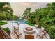 Inviting backyard with firepit, pool, and lush landscaping at 501 Harbor Point Rd, Longboat Key, FL 34228