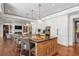 Open kitchen boasts an island, white cabinets, and hardwood floors at 501 Harbor Point Rd, Longboat Key, FL 34228
