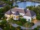 Luxury home with a circular driveway and lush landscaping at 501 Harbor Point Rd, Longboat Key, FL 34228