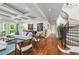 Open living area with hardwood floors, coffered ceilings, and a curved staircase at 501 Harbor Point Rd, Longboat Key, FL 34228