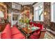 Sunlit dining room with botanical wallpaper and a large wooden table at 501 Harbor Point Rd, Longboat Key, FL 34228
