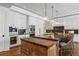 Modern kitchen features a large island, white cabinets, and a butler's pantry at 501 Harbor Point Rd, Longboat Key, FL 34228