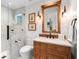 Bathroom with marble shower and wood vanity at 501 Harbor Point Rd, Longboat Key, FL 34228