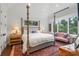 Large bedroom with a post bed and sitting area at 501 Harbor Point Rd, Longboat Key, FL 34228