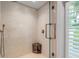 Spa-like shower with a built-in seat and beautiful mosaic tile at 501 Harbor Point Rd, Longboat Key, FL 34228