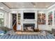 Spacious living room with fireplace, built-in bookshelves, and large TV at 501 Harbor Point Rd, Longboat Key, FL 34228