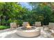 Modern fire pit surrounded by lush tropical plants at 501 Harbor Point Rd, Longboat Key, FL 34228
