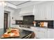 Well-equipped kitchen with professional range, custom cabinetry, and granite countertops at 501 Harbor Point Rd, Longboat Key, FL 34228