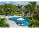 Inviting freeform pool and spa with lush landscaping at 501 Harbor Point Rd, Longboat Key, FL 34228