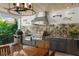 Granite countertop outdoor kitchen with stainless steel appliances and wood table at 501 Harbor Point Rd, Longboat Key, FL 34228