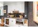 Modern bar with white shaker cabinets, granite countertop and beverage fridge at 501 Harbor Point Rd, Longboat Key, FL 34228