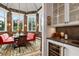 Breakfast area with red banquettes, tropical wallpaper, and a chandelier at 501 Harbor Point Rd, Longboat Key, FL 34228