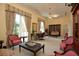 Spacious library with a large bookshelf, comfortable seating and a grand chandelier at 800 N Tamiami Trl # 1412, Sarasota, FL 34236