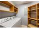 Laundry room with washer, dryer, and shelving at 800 N Tamiami Trl # 1412, Sarasota, FL 34236