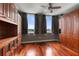 Bedroom with hardwood floors and a built-in wall unit at 800 N Tamiami Trl # 1412, Sarasota, FL 34236