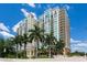 Luxury high-rise building with palm trees and a fountain at 800 N Tamiami Trl # 1412, Sarasota, FL 34236
