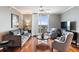 Living room with hardwood floors, balcony access, and city views at 800 N Tamiami Trl # 1412, Sarasota, FL 34236