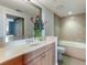 Bathroom with a large soaking tub and updated vanity at 800 N Tamiami Trl # 1412, Sarasota, FL 34236