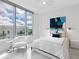 Bright bedroom featuring a large window with a city view and a white bed at 111 S Pineapple Ave # 605, Sarasota, FL 34236