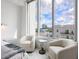 Bright bedroom features a large window and comfortable chairs with a city view at 111 S Pineapple Ave # 605, Sarasota, FL 34236