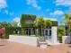 Outdoor image of The Bijou Cafe with a facade covered in lush greenery and tropical plants at 111 S Pineapple Ave # 605, Sarasota, FL 34236