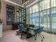 This conference room features modern lighting, blue chairs, and decorative curtains at 111 S Pineapple Ave # 605, Sarasota, FL 34236