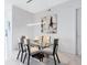 This dining room features sleek furniture, modern art, and bright lighting fixtures at 111 S Pineapple Ave # 605, Sarasota, FL 34236