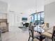 Bright dining room features modern lighting, a glass table, and a balcony with city views at 111 S Pineapple Ave # 605, Sarasota, FL 34236
