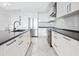 Modern kitchen with sleek white cabinetry, stainless steel appliances, and stone countertops at 111 S Pineapple Ave # 605, Sarasota, FL 34236