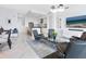 Modern living room with a sleek entertainment center, stylish furniture, and bright white tile at 111 S Pineapple Ave # 605, Sarasota, FL 34236