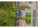 Beautiful aerial view of several homes, showcasing the well-manicured lawns and sparkling pools at 16215 Tradewind Ter, Lakewood Ranch, FL 34211