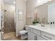 Well-lit bathroom featuring a glass-enclosed shower, white vanity with a quartz countertop and modern fixtures at 16215 Tradewind Ter, Lakewood Ranch, FL 34211