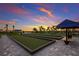 Several bocce ball courts are framed by palm trees and the colors of the sunset at 16215 Tradewind Ter, Lakewood Ranch, FL 34211