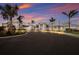 Elegant clubhouse exterior with palm trees set against a stunning sunset sky at 16215 Tradewind Ter, Lakewood Ranch, FL 34211