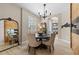 Elegant dining room featuring a round table, wood accent wall and a decorative mirror that enhances the space at 16215 Tradewind Ter, Lakewood Ranch, FL 34211