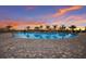 Stunning swimming pool with lounge chairs around the pool deck and an amazing sunset backdrop at 16215 Tradewind Ter, Lakewood Ranch, FL 34211