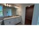 Bathroom with double vanity, granite countertops, and a walk-in closet at 2132 Nordendale Blvd, North Port, FL 34288